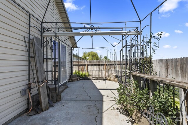 view of patio featuring fence