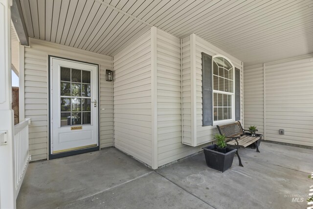 view of exterior entry with a porch