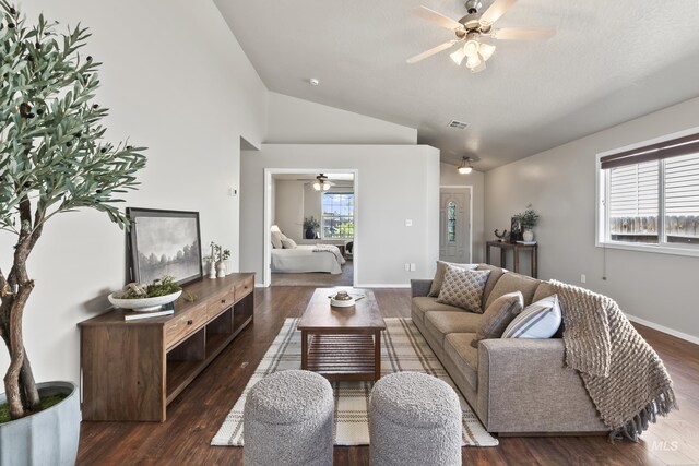 living room featuring visible vents, ceiling fan, wood finished floors, and lofted ceiling