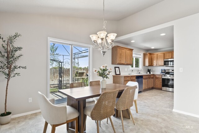 dining area featuring an inviting chandelier, baseboards, and recessed lighting