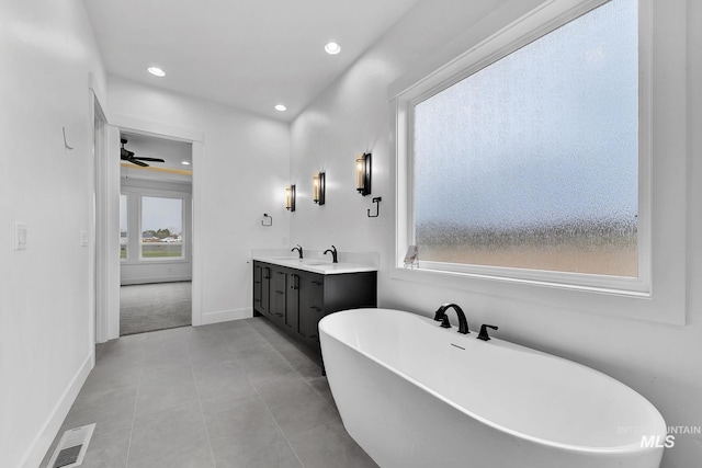 bathroom with ceiling fan, a bathtub, vanity, and tile patterned flooring