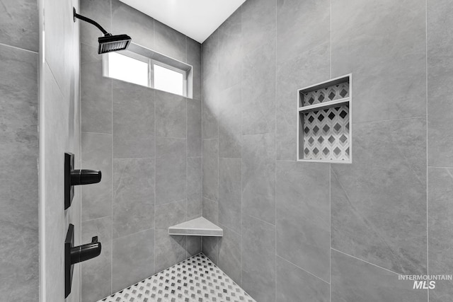 bathroom with tiled shower