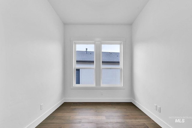 unfurnished room with dark hardwood / wood-style floors