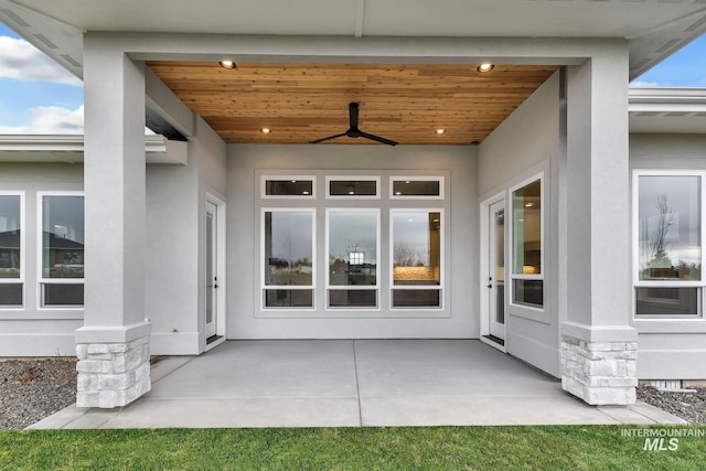 doorway to property featuring ceiling fan and a patio area