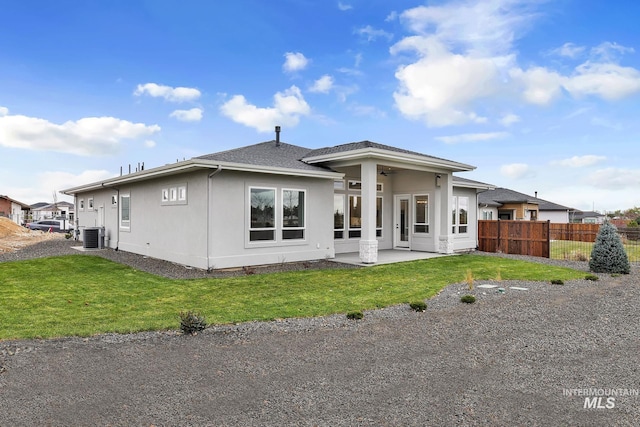 back of house featuring ceiling fan, a patio area, central air condition unit, and a yard