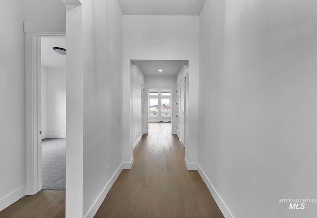 hallway with hardwood / wood-style flooring