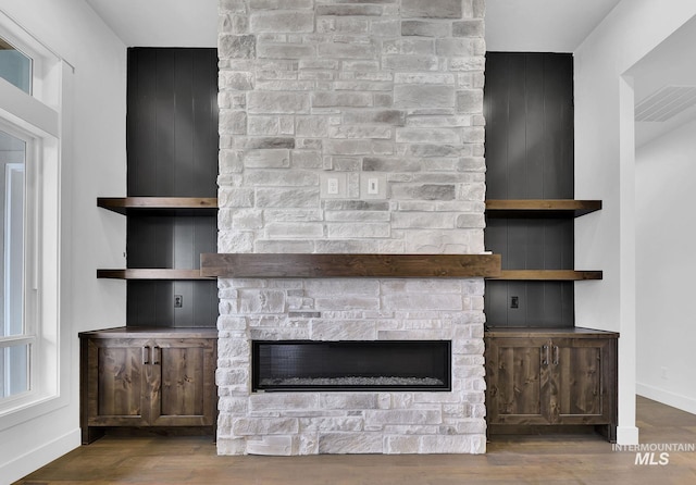 room details featuring a fireplace and hardwood / wood-style flooring