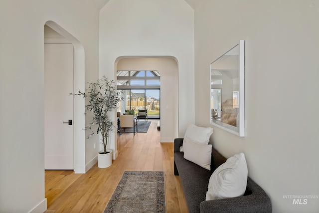 hallway with hardwood / wood-style flooring