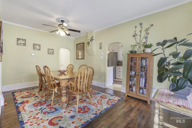 411 E 6th Ave, Twin Falls, ID 83301 - dining room featuring arched walkways, wood finished floors, ornamental molding, ceiling fan, and baseboards