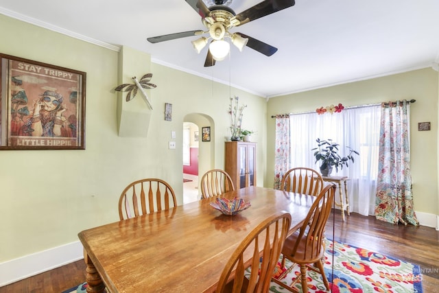 411 E 6th Ave, Twin Falls, ID 83301 - dining space featuring arched walkways, baseboards, wood finished floors, crown molding, and a ceiling fan