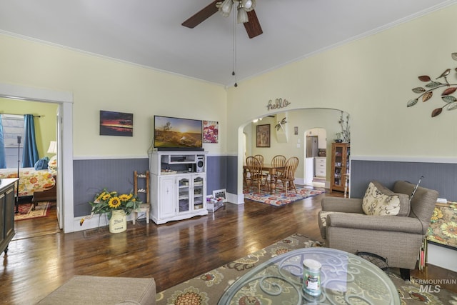 411 E 6th Ave, Twin Falls, ID 83301 - living room featuring arched walkways, wood finished floors, a ceiling fan, ornamental molding, and wainscoting