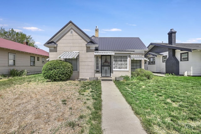 411 E 6th Ave, Twin Falls, ID 83301 - bungalow-style house with a front yard, metal roof, and a chimney