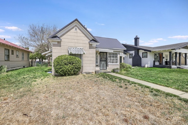 411 E 6th Ave, Twin Falls, ID 83301 - single story home featuring a front yard, a chimney, and metal roof