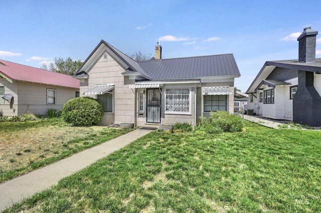 411 E 6th Ave, Twin Falls, ID 83301 - bungalow-style home featuring a front yard, metal roof, and a chimney
