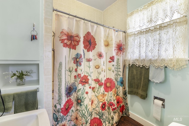 411 E 6th Ave, Twin Falls, ID 83301 - bathroom featuring curtained shower and wood finished floors