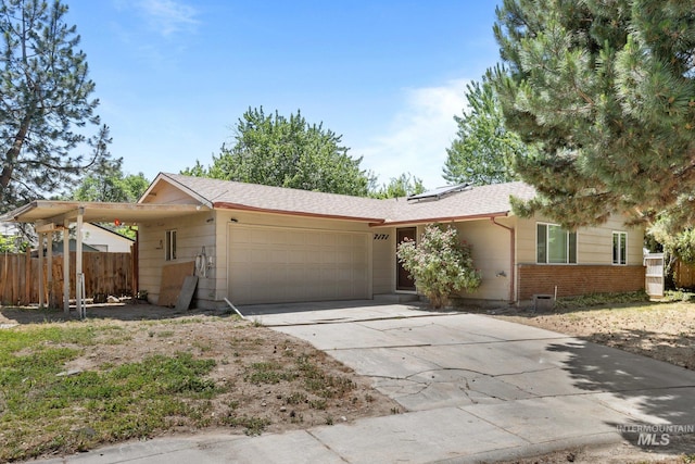 7171 Bluebird, Boise, ID 83703 - ranch-style house with an attached garage, concrete driveway, solar panels, brick siding, and roof with shingles