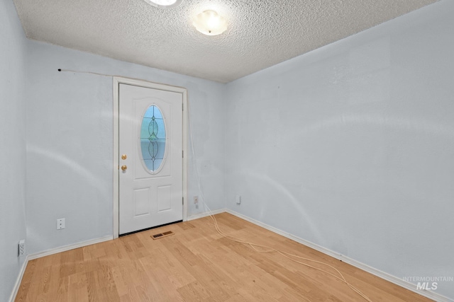 7171 Bluebird, Boise, ID 83703 - entrance foyer featuring a textured ceiling and light wood-type flooring