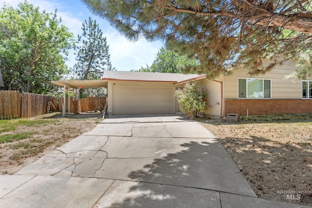 7171 Bluebird, Boise, ID 83703 - view of front of home featuring a garage, concrete driveway, and brick siding