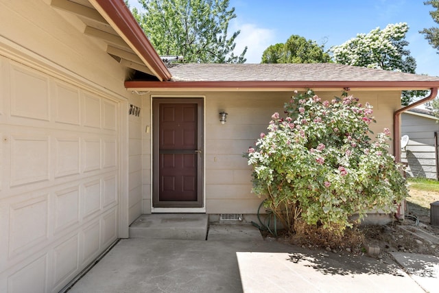 7171 Bluebird, Boise, ID 83703 - doorway to property with a shingled roof, a garage, and crawl space