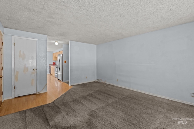7171 Bluebird, Boise, ID 83703 - carpeted spare room featuring a textured ceiling and baseboards