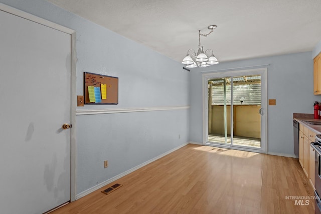 7171 Bluebird, Boise, ID 83703 - unfurnished dining area featuring a chandelier and light wood-style flooring