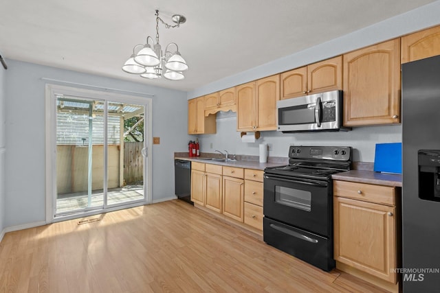 7171 Bluebird, Boise, ID 83703 - kitchen with black appliances, light brown cabinetry, a chandelier, and light wood-style floors