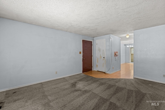 7171 Bluebird, Boise, ID 83703 - carpeted empty room featuring a chandelier and a textured ceiling