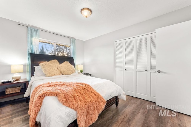 bedroom with wood-type flooring and a closet