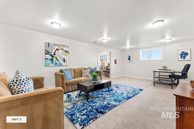 living room featuring light colored carpet and a textured ceiling