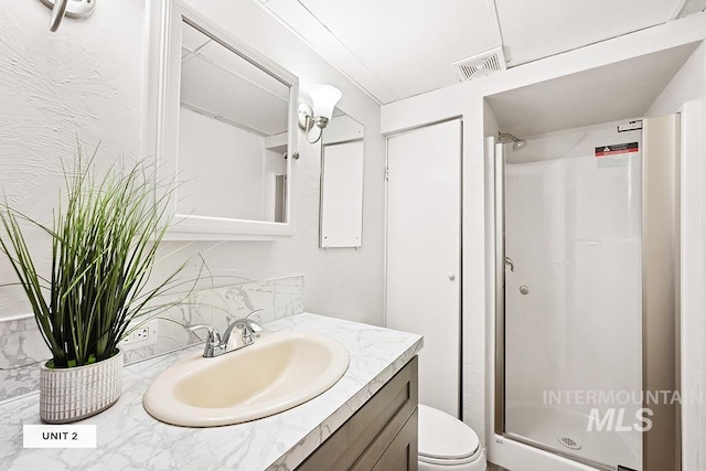 bathroom with a shower, toilet, and vanity