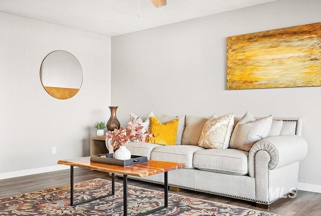 living room with ceiling fan and dark hardwood / wood-style flooring