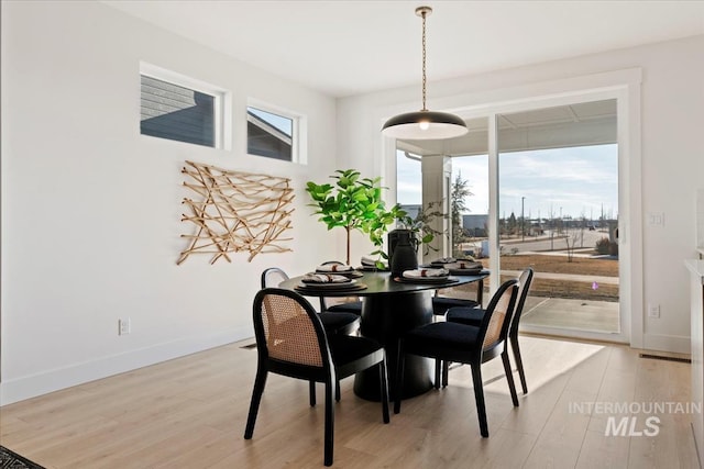 dining area with light hardwood / wood-style flooring