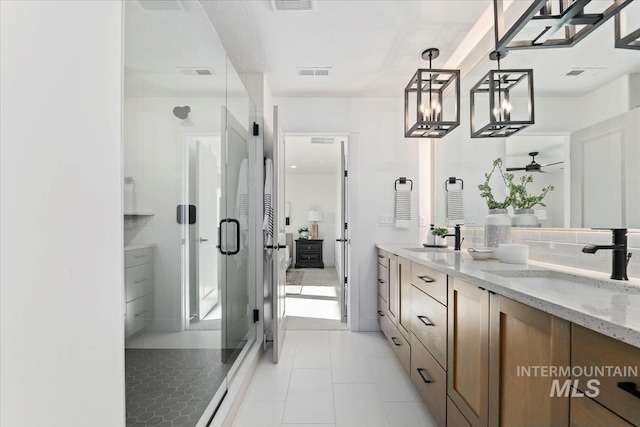 bathroom with walk in shower, vanity, ceiling fan, tile patterned flooring, and backsplash