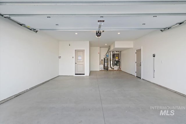 garage featuring heating unit, a garage door opener, and water heater