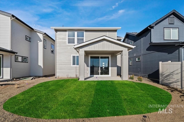 rear view of property featuring a yard