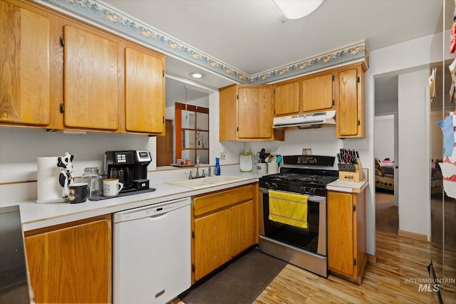 4667 S Shawnee Way, Boise, ID 83709 - kitchen with dishwasher, gas range, under cabinet range hood, light wood-style floors, and light countertops