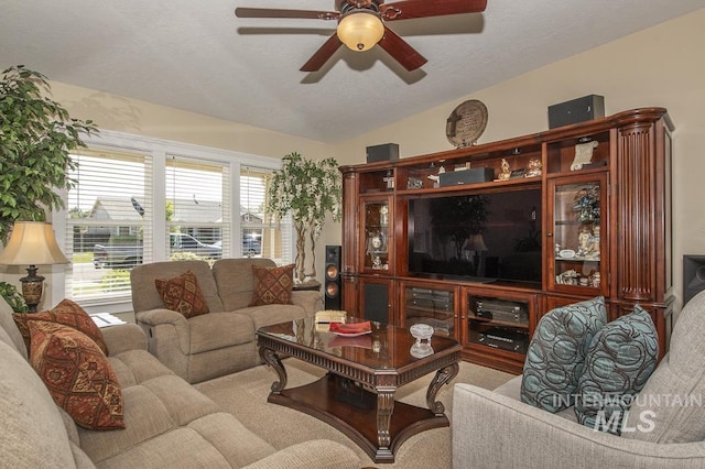 carpeted living room with ceiling fan and a textured ceiling