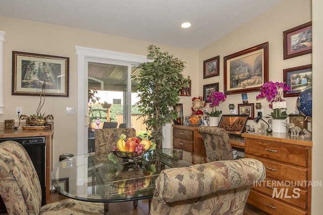 dining space with wood finished floors and recessed lighting
