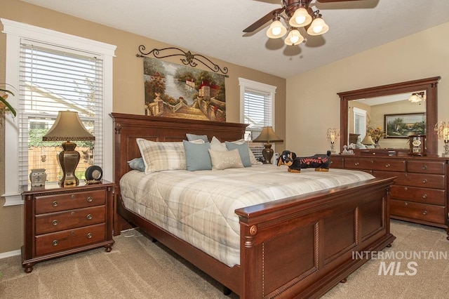 bedroom featuring light carpet and a ceiling fan