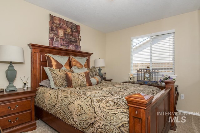 carpeted bedroom featuring baseboards