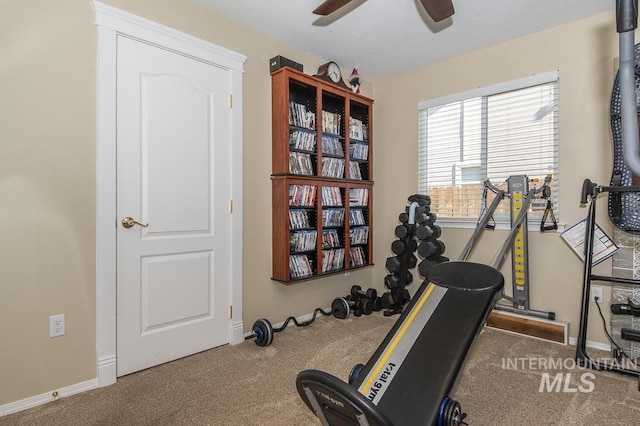 workout area with carpet floors, ceiling fan, and baseboards