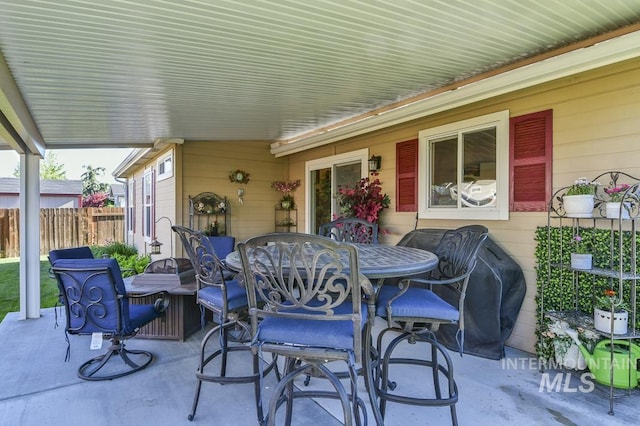 view of patio with fence and outdoor dining area