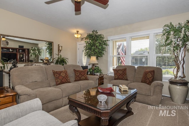 living room featuring a ceiling fan and carpet flooring