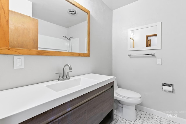 1015 24th St, Lewiston, ID 83501 - full bathroom with toilet, baseboards, vanity, a shower, and tile patterned floors