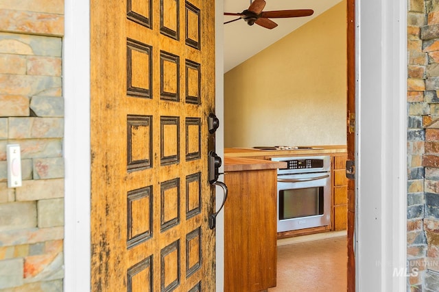 1015 24th St, Lewiston, ID 83501 - kitchen with stainless steel oven, a ceiling fan, lofted ceiling, brown cabinetry, and cooktop