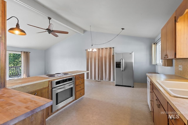 1015 24th St, Lewiston, ID 83501 - kitchen with stainless steel appliances, a sink, brown cabinetry, and a ceiling fan