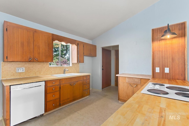 1015 24th St, Lewiston, ID 83501 - kitchen with white appliances, a sink, lofted ceiling, decorative backsplash, and brown cabinets