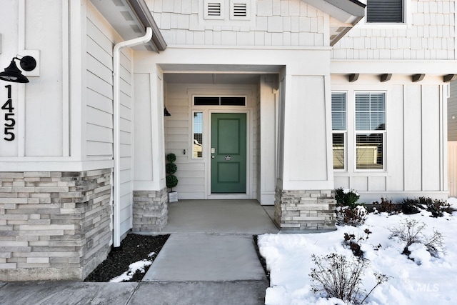 view of snow covered property entrance