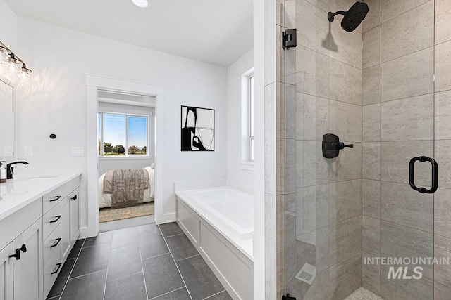 3389 E Englehart Dr, Meridian, ID 83642 - ensuite bathroom with a bath, a stall shower, vanity, and tile patterned flooring