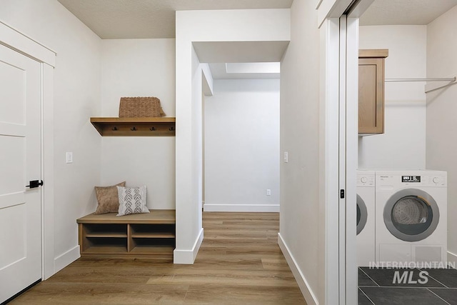 3389 E Englehart Dr, Meridian, ID 83642 - washroom with light wood finished floors, cabinet space, and washing machine and clothes dryer